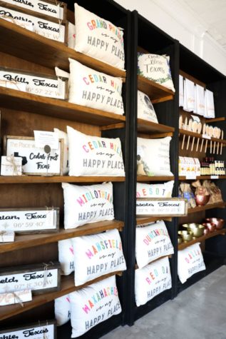 Pillows, signs and baking items are displayed across the wall Oct. 30 at The Market. Personalized items can be bought for cities across the Metroplex.