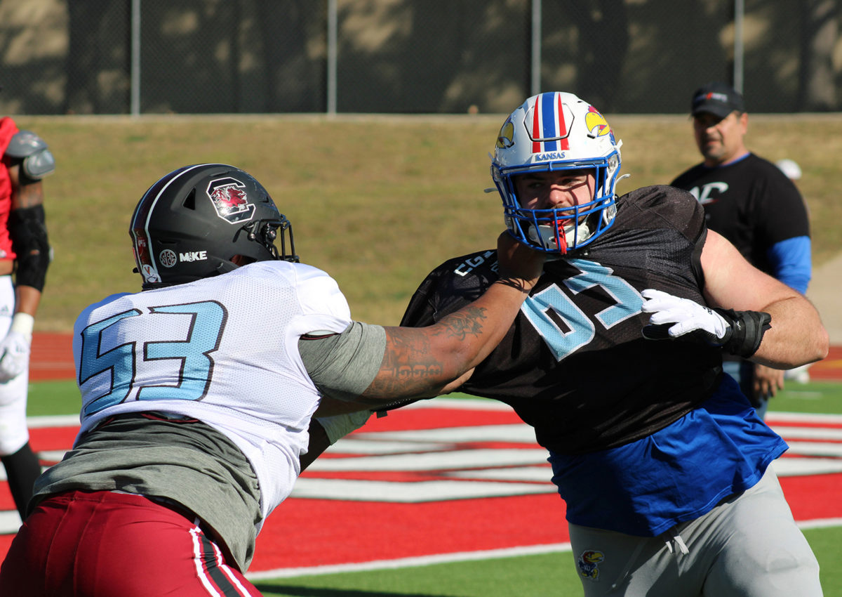 Eric Douglas from the University of South Carolina grabs the jersey of Kansas University's Sam Burt on Jan. 10, 2023, at Farrington Field in Fort Worth, Texas.