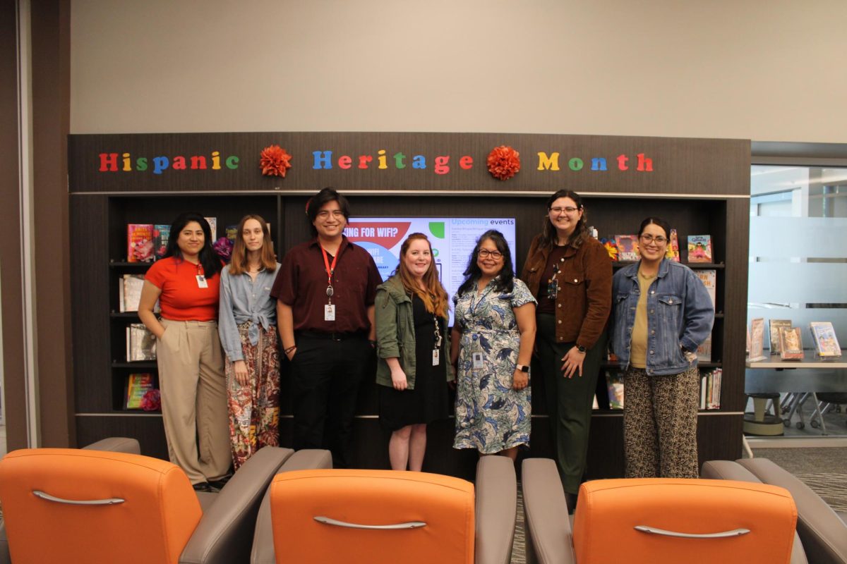 Librarians at Arlington's East Library and Recreation Center pose in front of a Hispanic Heritage Month display. Hispanic Heritage Month runs through Oct. 15.