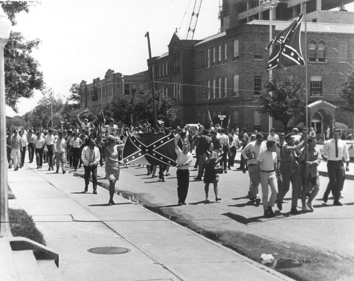 Students waving Confederate battle flags protest in spring 1968 to retain the Rebel theme at the University of Texas at Arlington. Source: Rebel Theme Controversy Collection, Special Collections, The University of Texas at
Arlington Libraries.