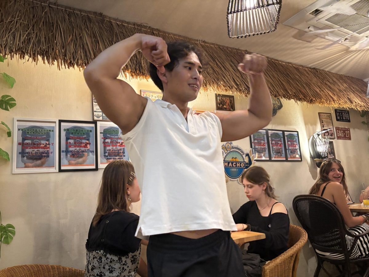 One of the Macho Bar's macho men flexes for customers. The Macho Bar in Kyoto, Japan, offers power poses, princess carries and drinks juiced by raw muscles.