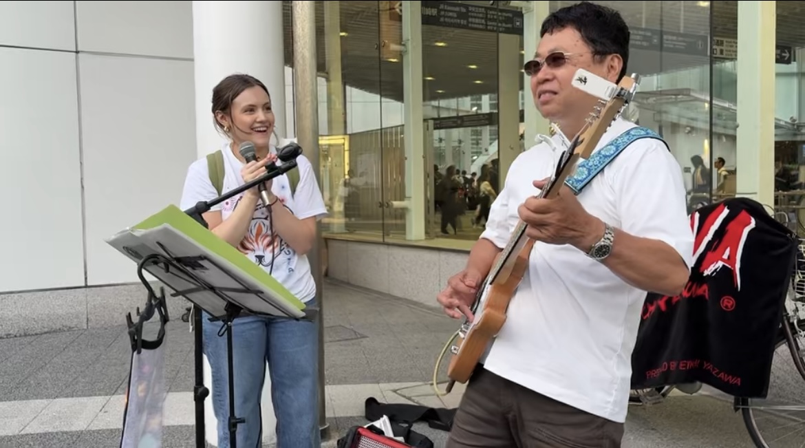 Diana Garcia, left, and Eikichi enjoy connection through music near Kawasaki Station in Kawasaki, Japan.