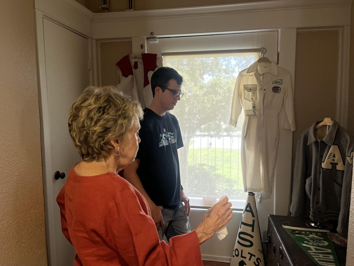 Arlington Historical Society board member Rebecca Tucker shares stories about college and high school football traditions with a visitor at the Fielder House Museum.