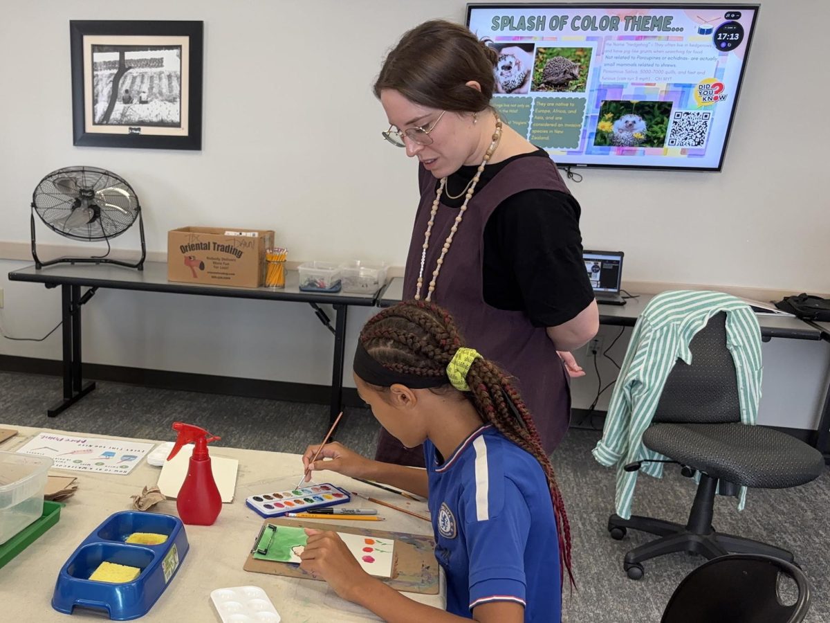 Librarian Emily Allen checks in with a young artist at the Tween Watercolor Workshop at the Arlington Public Library’s Southwest Branch on September 9, 2025.
