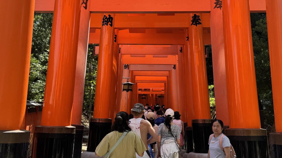 A series of vermilion torii gates lead visitors up Inariyama in Kyoto, Japan.