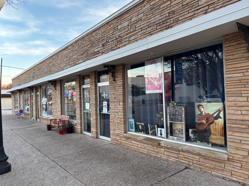 The outer windows of F6 Art Lounge covered in posters of musical legends Bob Dylan and Jimi Hendrix