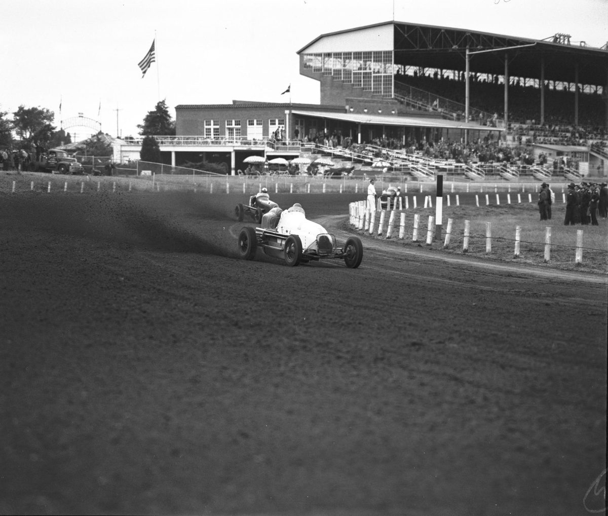Ted Horn as he skidded around first turn in a race car on the 46th lap with Duke Nalon following closely behind during a Nov. 2, 1947, race at Arlington Downs. Courtesy, Fort Worth Star-Telegram Collection, Special Collections, The University of Texas at Arlington Libraries.